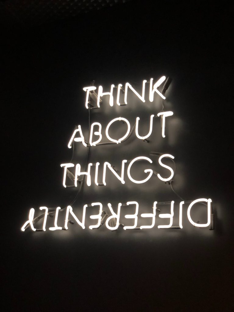lighting sign what says: think about things differently