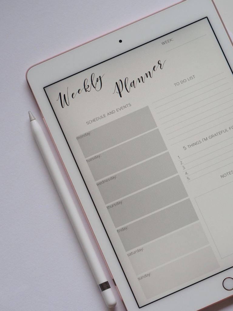 An ipad with a weekly planner pge